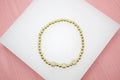 18K Gold Filled 4mm Gold Elastic Bead Bracelet With Three Round CZ Charm  (I30)